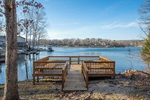 Another view of the lovely lakeside deck, which features wooden benches in each corner.
