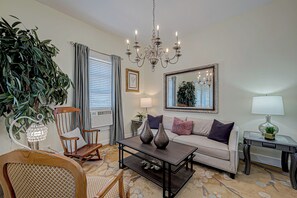 Nice relaxing living space with hardwoods, tall ceilings + designer chandelier!