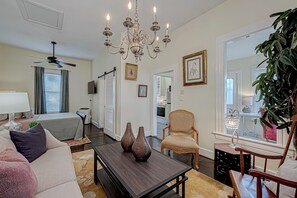 Living and sleeping area, porch w/ desk to the right. 
