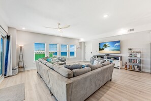 Spacious Living Room with 75" smart TV, and secure high speed WiFi access