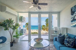 Living Room – Bright, coastal-chic vibes with panoramic beach views that bring paradise right to your sofa.









