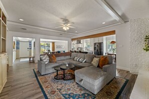 Relax and unwind in the heart of the home, featuring a cozy fireplace, plush seating, and a Smart TV for movie nights.