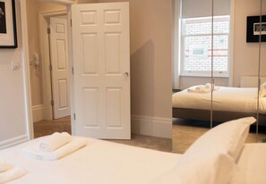 The main bedroom features a spacious mirrored cabinet.