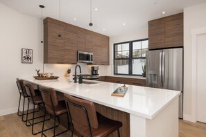 Open concept dining / kitchen area with breakfast bar and fully stocked kitchen