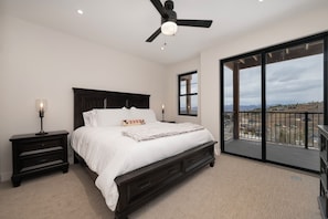 Primary suite with bathroom, king bed, 43" smart TV, and private patio