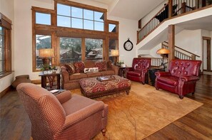 Living area featuring a gas fireplace, TV, ample seating and access to the private deck.
