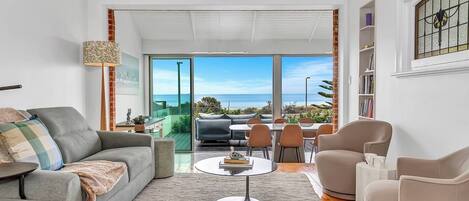 The main living and dining space invites you to relax with breathtaking ocean views and a bright, airy layout.