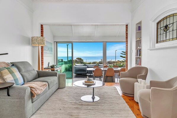 The main living and dining space invites you to relax with breathtaking ocean views and a bright, airy layout.
