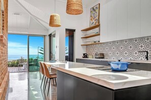 Cook with ease in the modern kitchen, showcasing sleek cabinetry, high-end appliances, and a stunning patterned backsplash.
