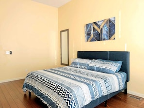 This king-sized bedroom offers the perfect retreat for relaxation and comfort.