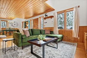 Main floor living room with a smart TV, wood stove, and board games.