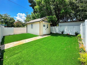 Enclosed yard with artificial grass/ synthetic turf.  No dogs or cats allowed