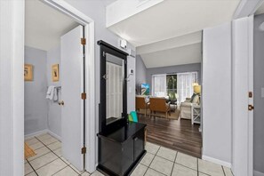 The tiled entry has a full guest bath