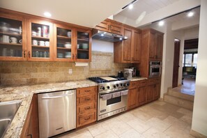 High-end features include a Viking range and KitchenAid appliances.