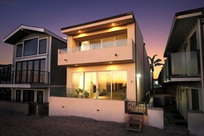 A serene oceanfront retreat with stunning island views at the beach on the sand.