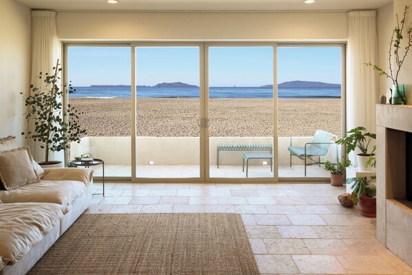 A serene oceanfront retreat with stunning island views at the beach on the sand.