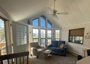 Living area with great views and high ceilings and a ceiling fan!