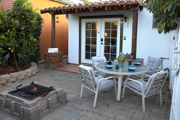 Private fenced patio with fire pit and French doors to your living room