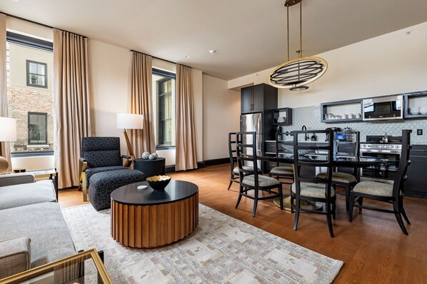 Spacious living and dining area featuring soft neutral tones and an abundance of natural light, offering a relaxing and welcoming atmosphere.