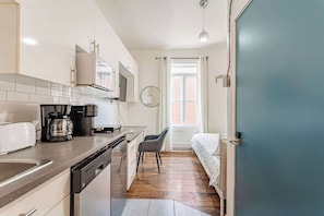 Bright kitchenette with modern appliances and ample counter space for meal prep.