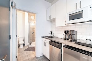 Fully equipped kitchenette with a microwave, fridge, and everything you need for simple meals.
