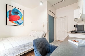 Comfortable sleeping area with vibrant wall art and a calming, minimalistic design.