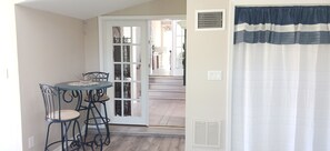 view from living room thru doors to kitchen & bathroom.  the curtain area is W/D