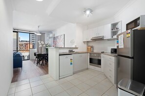 The kitchen seamlessly opens to the dining area, creating a bright and airy space that enhances both cooking and dining experiences.