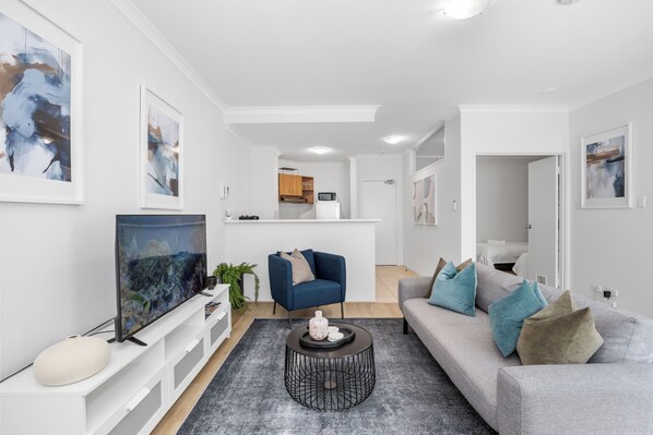 Experience modern living in an open-concept space, seamlessly connecting the living, dining, and kitchen areas, perfect for entertaining and everyday living.