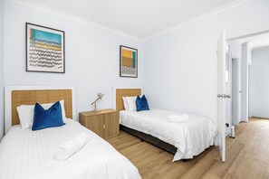 Rest comfortably in a well-appointed twin bedroom, featuring two cozy beds with plush bedding and stylish accents, perfect for relaxation.
