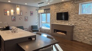 Huge kitchen, with large island, fireplace and standing desk. Lots of light!