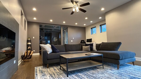 Huge living room with fireplace, balcony & standing desk 