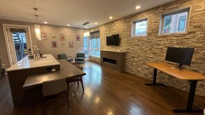 Huge kitchen, with large island, fireplace and standing desk. Lots of light!