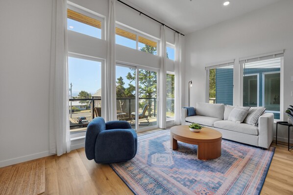 Bright and modern living room with large windows and a private balcony. 