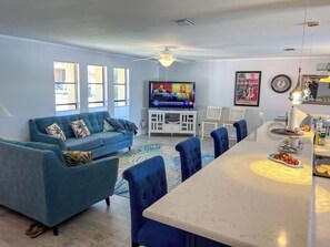 Bright and cozy living room with a bar facing the kitchen.
