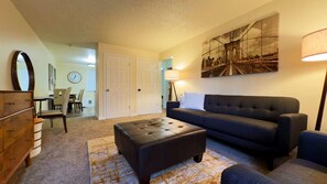 Cozy living room with 60" smart tv.  Board games in tv console.  Black out curtains. 