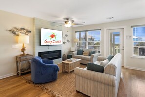 Living room with electric fireplace and gulf views