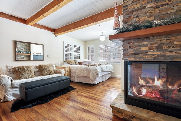 Living room with King bed and gas fireplace (not shown is new floor-to-ceiling drapery to close off King bed from living area