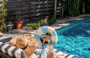 Take a dip in the heated pool or relax poolside with a cocktail in hand. The striped umbrellas and loungers add a touch of resort-style luxury.