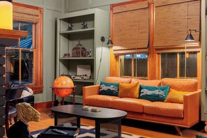 Rich green paneling, leather seating, and warm lighting set the tone for the Gentleman’s Room, offering a welcoming atmosphere for game nights or quiet conversation.