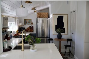 Kitchen is open to living space with lots of character
