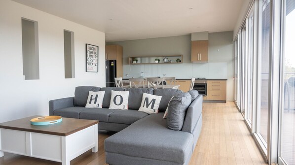 Open plan living dining/kitchen area with access to the outdoor deck.