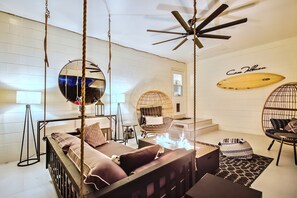 Relax outdoors on a suspended daybed with a fire feature and built-in speakers.
