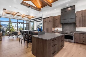 Kitchen into the Dining Room.  Huge 6 burner gas stove with griddle and double ovens.  