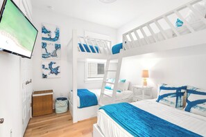 Bedroom #2 features bunks and a smart tv. (1) twin over twin, (1) twin over full