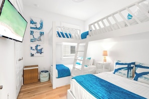 Bedroom #2 features bunks and a smart tv. (1) twin over twin, (1) twin over full