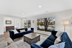 An inviting living space with plush seating, natural light, and scenic views.