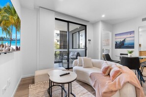 Relax on the chic boucle curved sofa and matching ottoman, adding a touch of contemporary style to your stay.