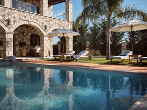 Enjoy the villa’s allure surrounded by the tranquil pool area.