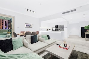 Living Room: Bright and stylish space with a modern kitchen and panoramic city views!